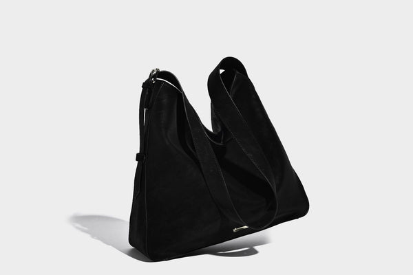 Large slouchy hobo shoulder bag in matte leather-look finish with adjustable strap and gold-tone bar hardware, detail view 17