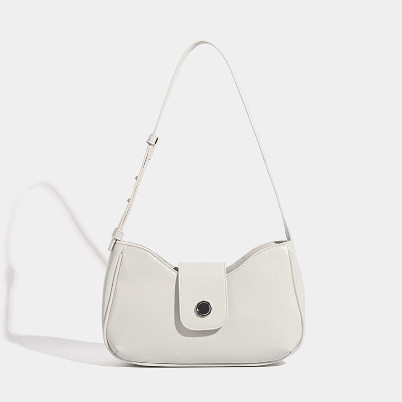 Compact glossy leather-look shoulder bag with round metal snap closure and contrast stitching, detail view 7