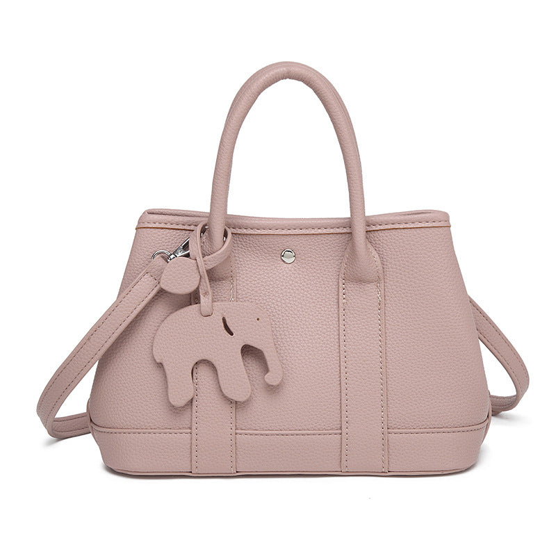 Structured pebbled leather-look top-handle tote bag with elephant charm and detachable shoulder strap, detail view 7