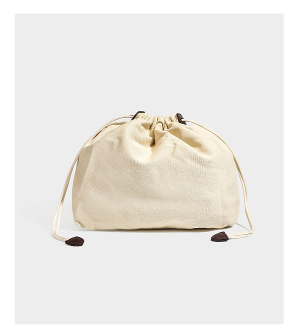 Dunkelbraune Tote-Bag in Lederoptik mit geflochtenen Henkeln, Kordelverschluss und befestigtem gewebtem Mini-Etui, Detailansicht