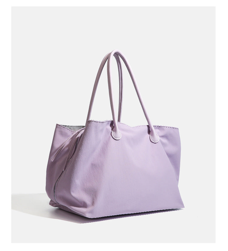 Large soft nylon tote bag with long double handles and zippered top in lavender, detail view 10