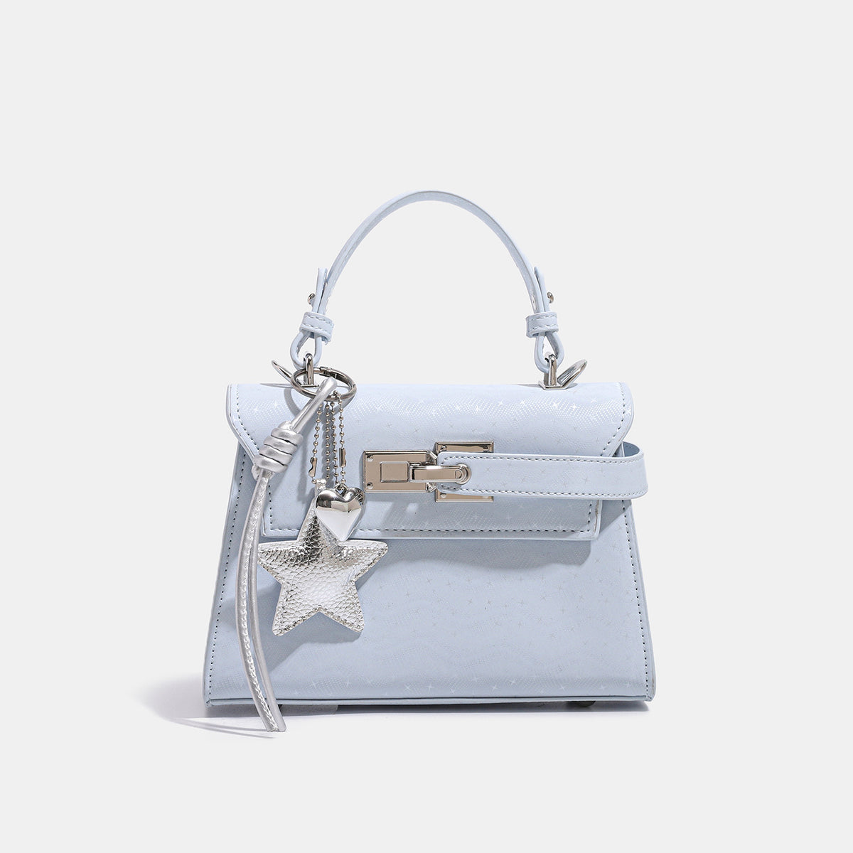 Mini structured trapezoid satchel with embossed textured finish, silver-tone turn-lock closure, star charm with cord tassels