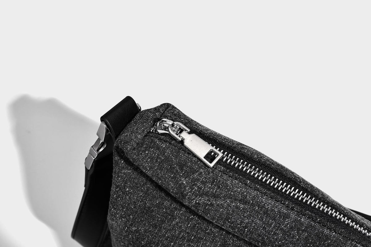 Charcoal denim-textured slouchy hobo bag with zip-top closure, silver-tone hardware, and adjustable leather-look crossbody