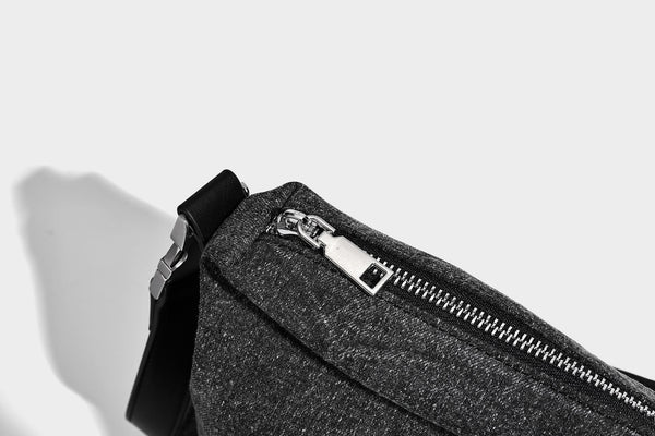 Charcoal denim-textured slouchy hobo bag with zip-top closure, silver-tone hardware, and adjustable leather-look crossbody