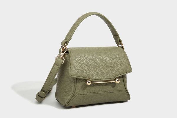 Small structured pebbled flap mini satchel with gold-tone bar hardware, short top handle, and detachable crossbody strap