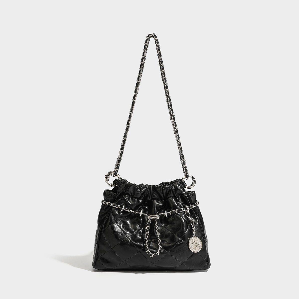 Glossy diamond-quilted drawstring bucket bag with silver chain shoulder strap and medallion charm, detail view 6