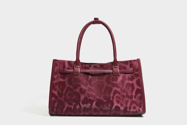 Structured leopard-print tote bag with glossy satin-like finish, dual rounded top handles, silver buckle-and-ring front