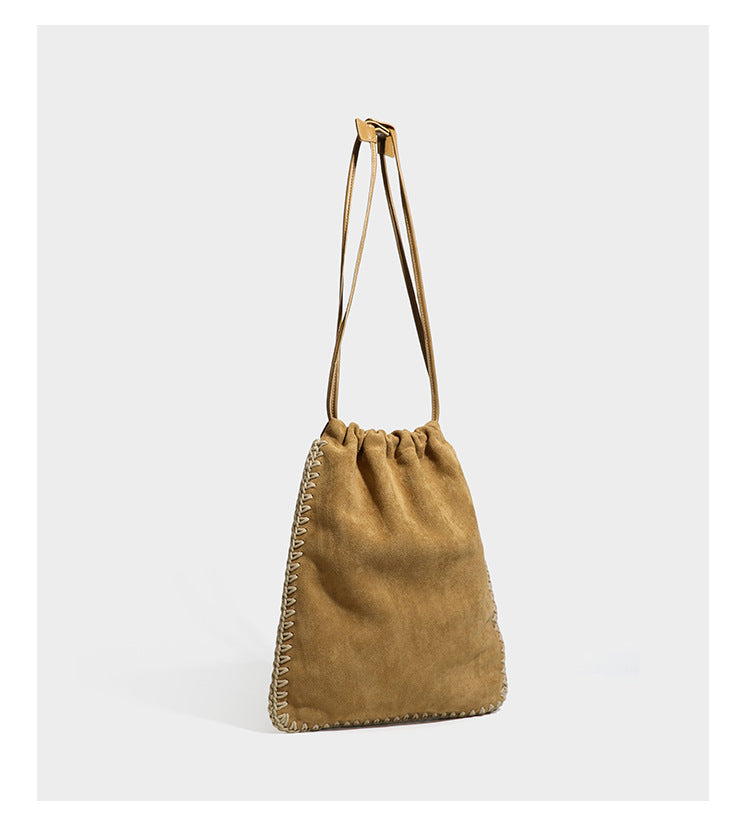 Matte suede-look drawstring bucket bag with cream braided woven edge trim and slim adjustable leather-look shoulder strap
