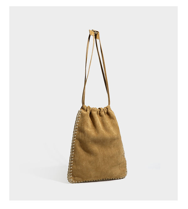 Matte suede-look drawstring bucket bag with cream braided woven edge trim and slim adjustable leather-look shoulder strap