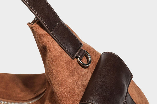 Slouchy cognac brown matte suede-look hobo shoulder bag with dark brown leather-look trim, top zip closure, front flap