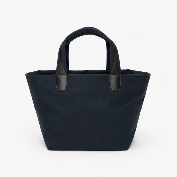 Large lightweight nylon tote bag with zipper closure, black leather-look handles, and trapezoid silhouette, detail view 7