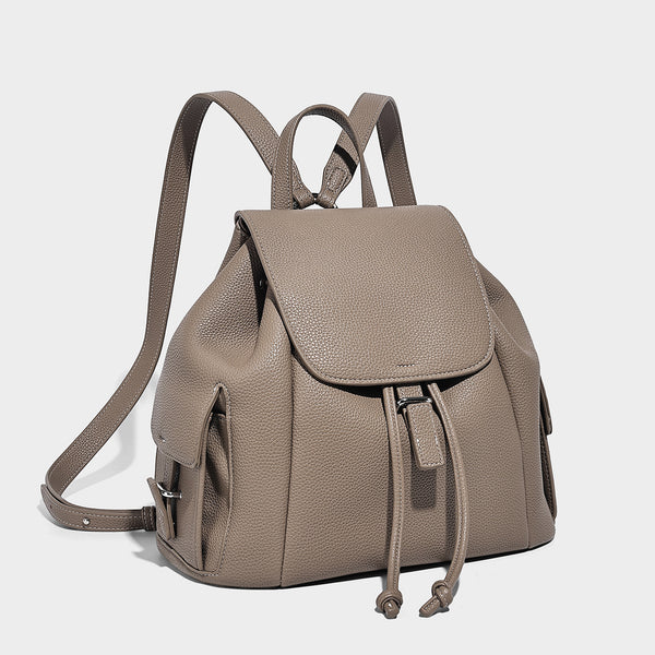 Compact pebbled leather-look flap drawstring backpack handbag with side pockets, top handle, and silver-tone hardware, front