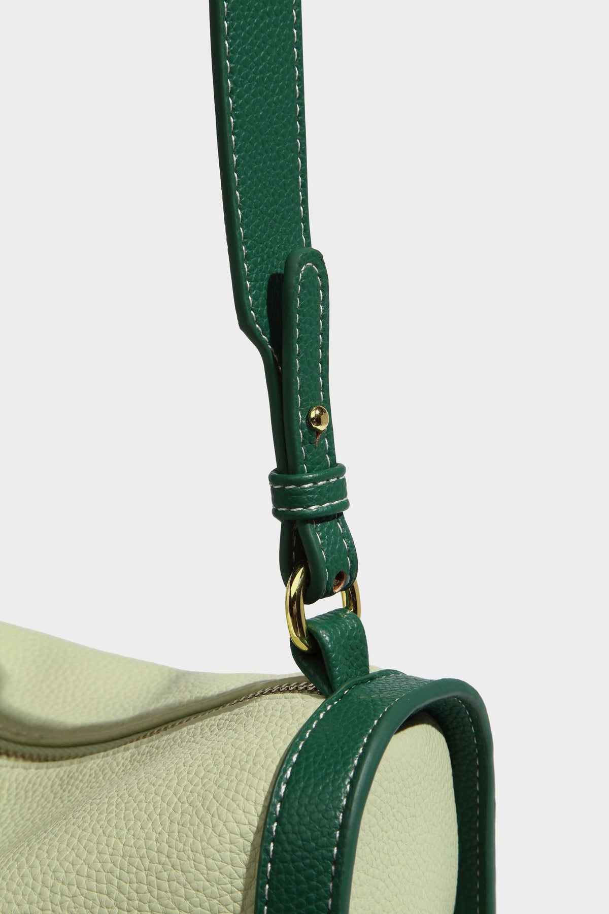 Structured two-tone shoulder bag with pebbled leather-look finish, contrast trim, top zip closure, and gold-tone hardware