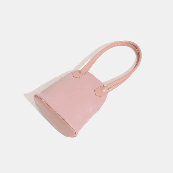 Rounded shell handbag with pebbled leather-look finish, dual top handles, and silver-tone zipper, detail view 4