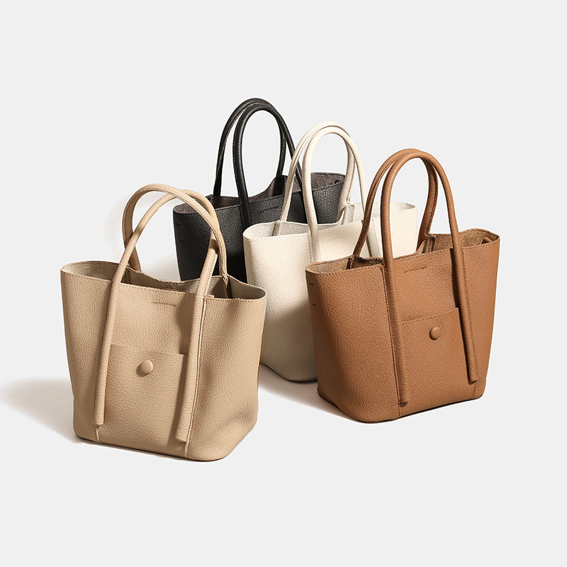 Structured pebbled matte tote bag with front snap pocket, dual top handles, and detachable zip pouch in almond beige, detail
