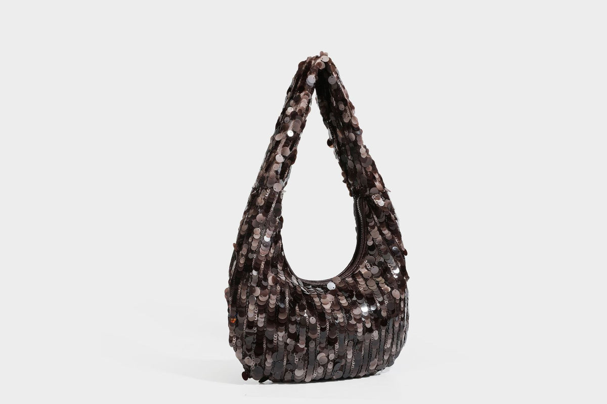 Slouchy crescent hobo shoulder bag covered in overlapping reflective sequin discs with a single integrated strap and top-zip