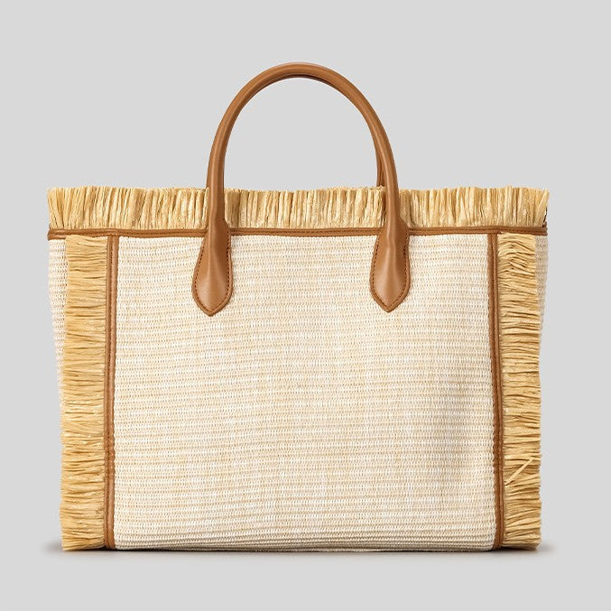Natural ivory woven straw tote bag with raffia fringe trim, cognac leather-look handles, Paris Milano embroidered script
