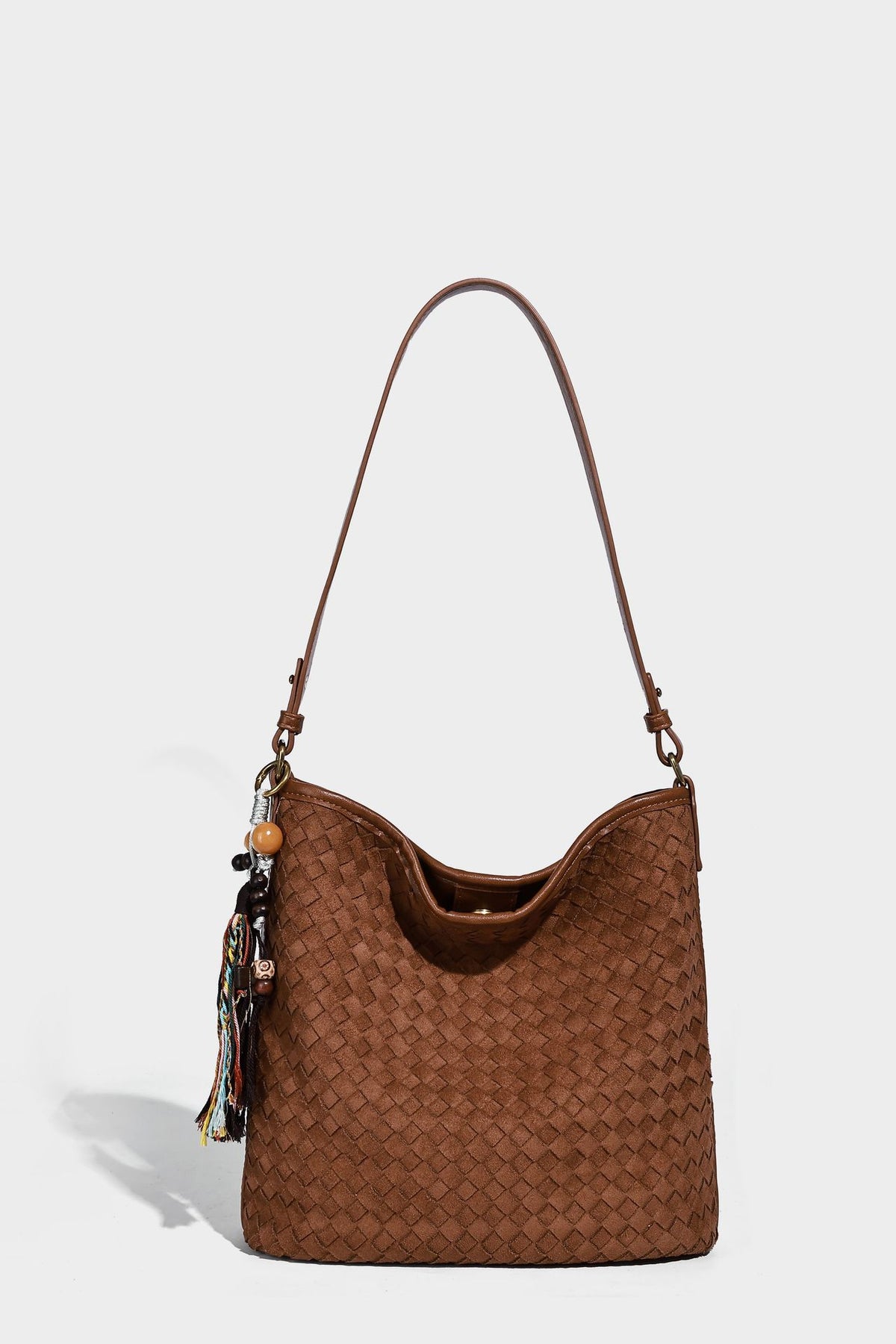Dark chocolate woven texture hobo shoulder bag with multicolor tassel-and-bead charm and long adjustable strap, detail view