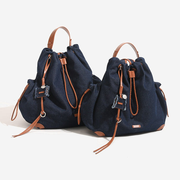 Weicher Rucksack in Beutelform mit Kordelzug und geflochtenem Kordelverschluss, Besätzen in hellbrauner Lederoptik und Eckenschutz, Detailansicht 3