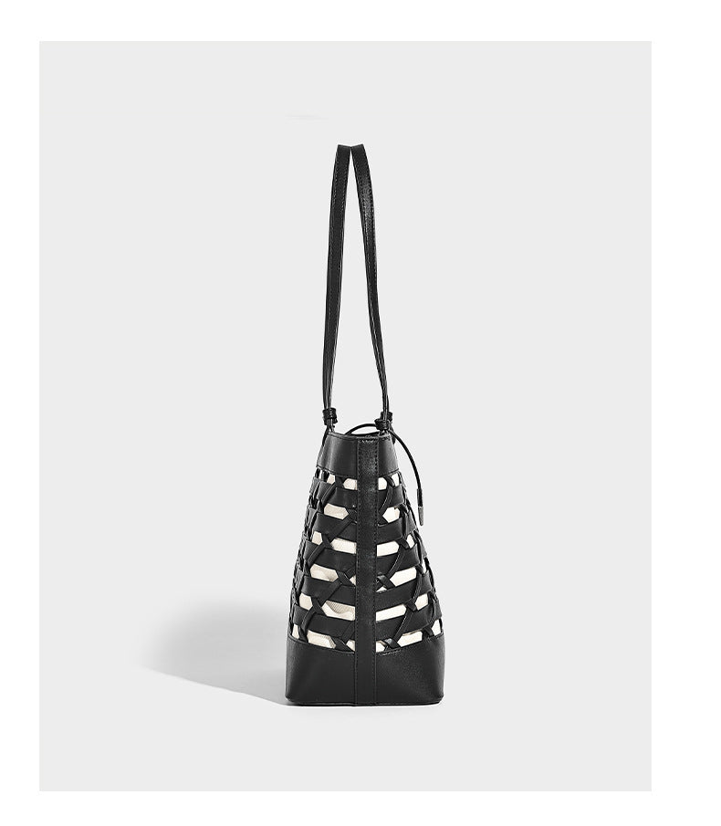 Structured woven lattice cutout tote bag with smooth leather-look trim, dual shoulder straps, and silver-tone hardware