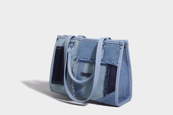 Structured patchwork denim tote bag with frayed panel seams, dual top handles, and silver-tone hardware, detail view 18