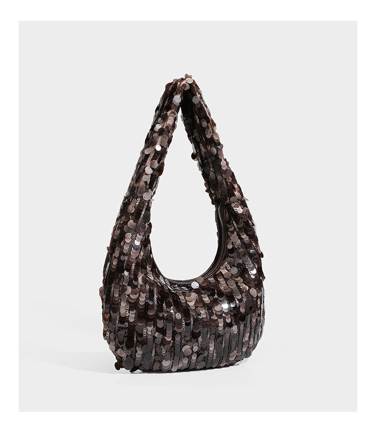 Slouchy crescent hobo shoulder bag covered in overlapping reflective sequin discs with a single integrated strap and top-zip