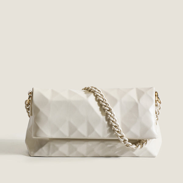 Cream white rectangular flap shoulder bag with geometric faceted surface and chunky tone-on-tone chain strap with gold-tone