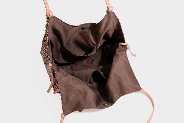 Large leopard print shoulder tote bag with glossy finish, long double straps, front zip pocket, silver-tone hardware, and