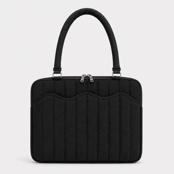 Quilted colorblock handbag with wavy scalloped front panel, padded arched top handles, and dual zip closure, detail view 9