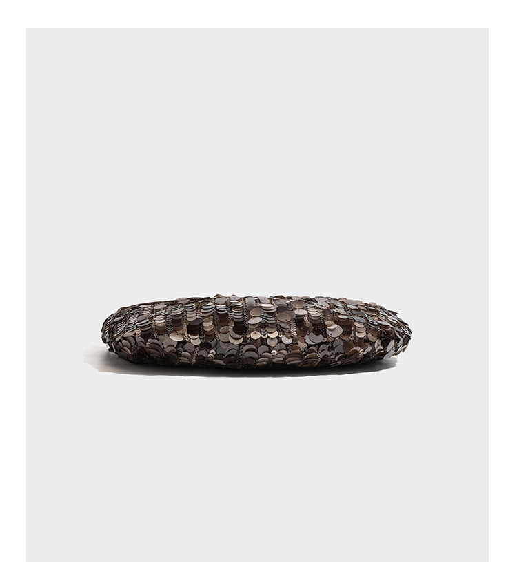 Small sequin half-moon handbag with circular wood-look ring handles and detachable leather-look shoulder strap, detail view