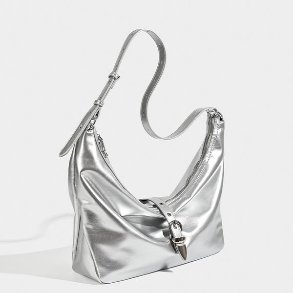 Slouchy crescent hobo bag with glossy leather-look finish, silver-tone buckle hardware, and flat shoulder strap, detail view