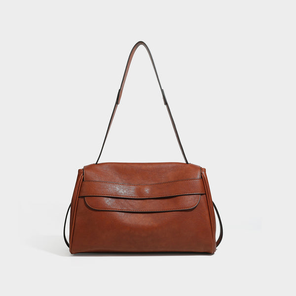 Structured rectangular flap shoulder bag in dark brown leather-look finish with long single strap and layered front panel