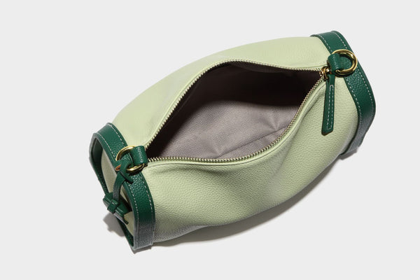 Structured two-tone shoulder bag with pebbled leather-look finish, contrast trim, top zip closure, and gold-tone hardware