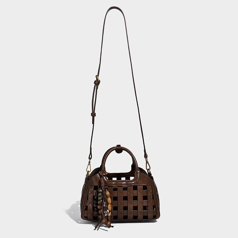 Small structured woven lattice top-handle satchel bag with bead-and-tassel charm and gold-tone hardware, detail view 3