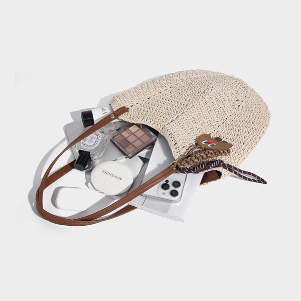 Woven crochet open-top shoulder tote bag with slim brown leather-look straps and braided charm accent, detail view 4