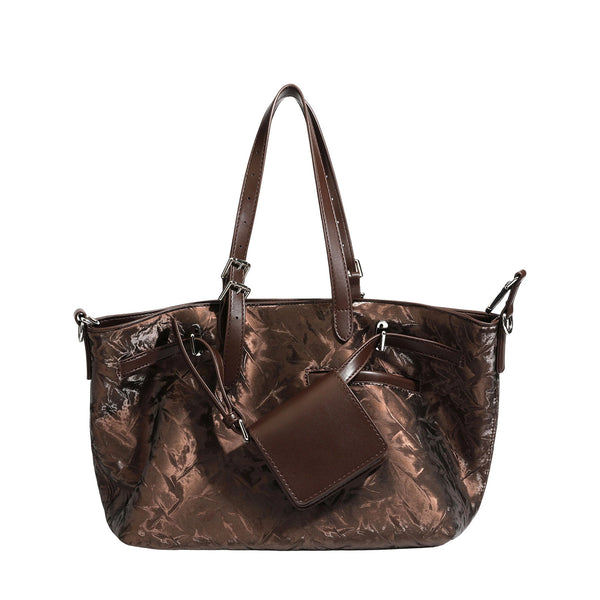 Glossy crinkled metallic-finish tote bag in brown with smooth leather-look top handles, silver-tone hardware, and attached