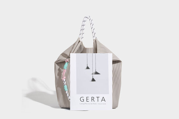 Slouchy pinstripe tote bag with braided rope handles, metal ring hardware, and colorful knotted rope charm, detail view 19