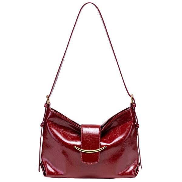 Glossy burgundy leather-look shoulder bag with curved gold-tone bar front closure, crinkled oil-wax texture, and adjustable