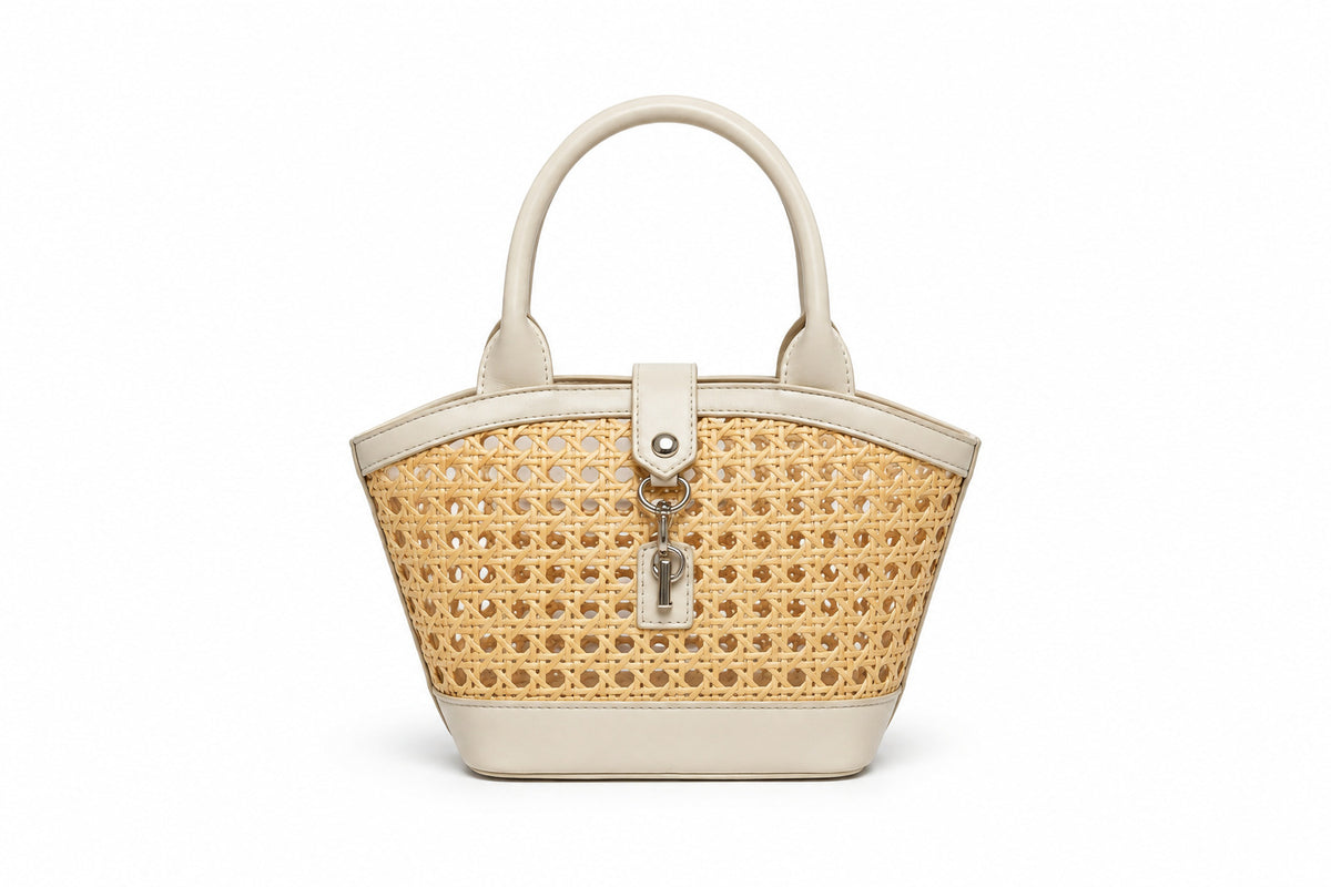 Structured mini tote bag with open-weave rattan body, leather-look arched handles and trim, front tab turn-lock closure, and