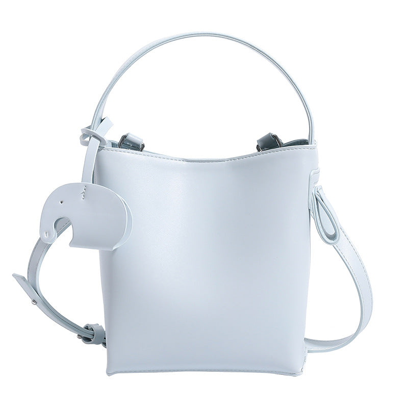 Mini-Bucket-Tasche mit strukturierter Form aus glatter, matter eisblauer Lederoptik, gewölbtem Tragegriff und abnehmbarem Crossbody-Riemen