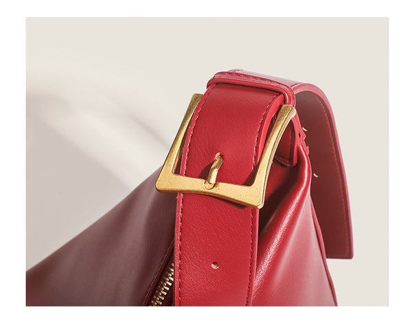 Large slouchy hobo shoulder bag in smooth leather-look finish with single long strap and gold-tone zip closure, detail view
