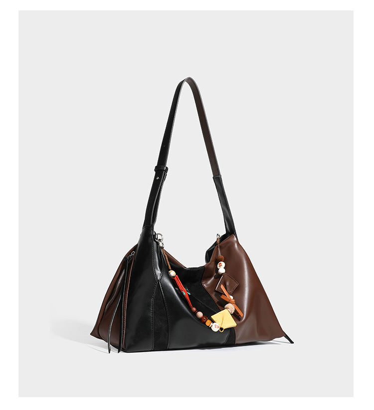 Two-tone black and brown leather-look slouchy shoulder bag with beaded tassel charm and silver-tone hardware, detail view 8