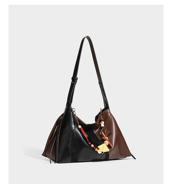 Two-tone black and brown leather-look slouchy shoulder bag with beaded tassel charm and silver-tone hardware, detail view 8