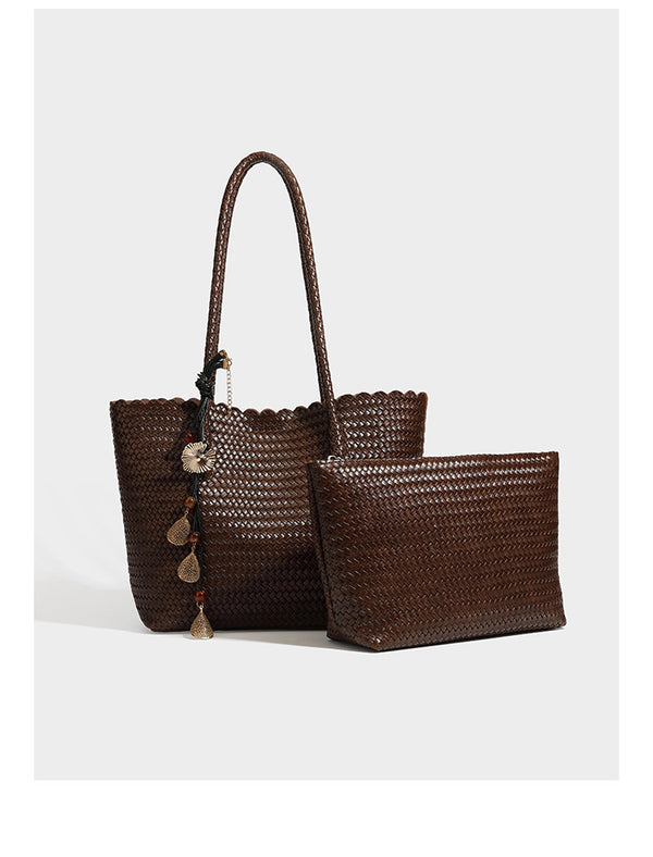 Large open-top woven leather-look tote bag in dark brown with scalloped edge, braided double shoulder straps, and decorative