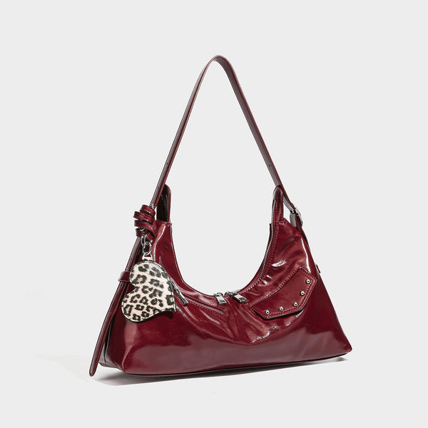 Glossy dark brown hobo shoulder bag with slim strap, front zip pocket, stud detail, and detachable leopard-print heart charm