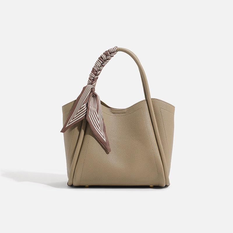 Pebbled leather-look bucket tote bag with scarf-wrapped top handle and gold-tone hardware, detail view 9