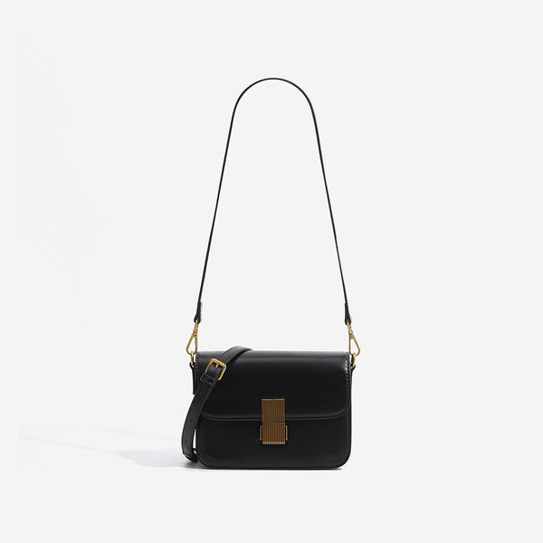 Mini structured black flap crossbody bag with gold-tone ribbed rectangular clasp and adjustable shoulder strap, detail view 6