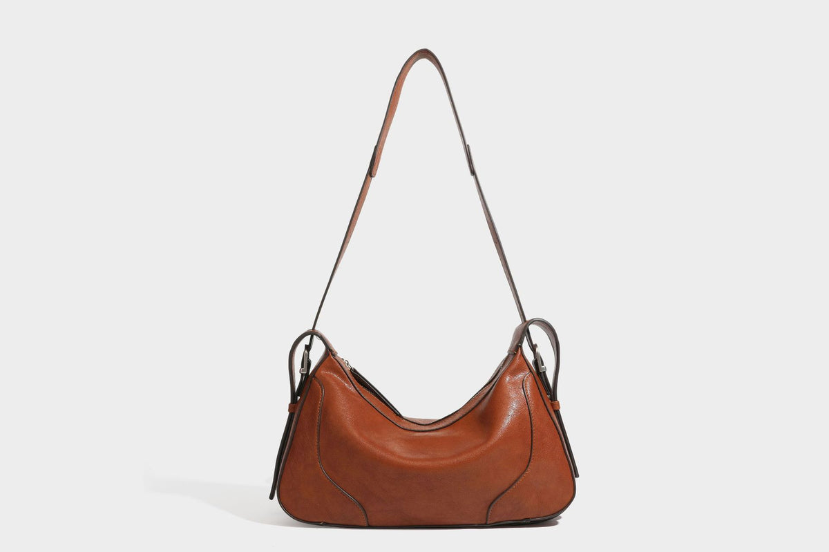 Slouchy crescent hobo shoulder bag in dark brown pebbled leather-look finish with zip top and long shoulder strap, detail