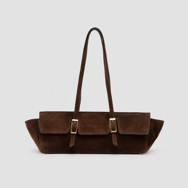 Wide trapezoid tote bag with matte suede-like finish, dual gold-tone buckle front pockets, and double flat shoulder straps