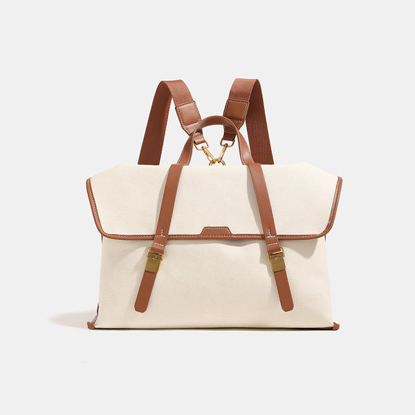 Structured flap-over backpack satchel in smooth leather-look finish with gold-tone buckle hardware and top handle, detail